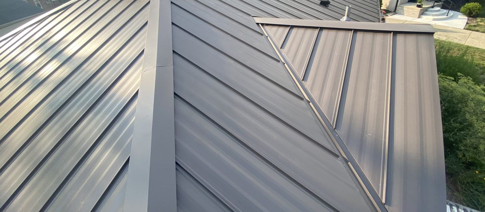Mechanical Seam 1½" standing seam panels with hip cap and transition